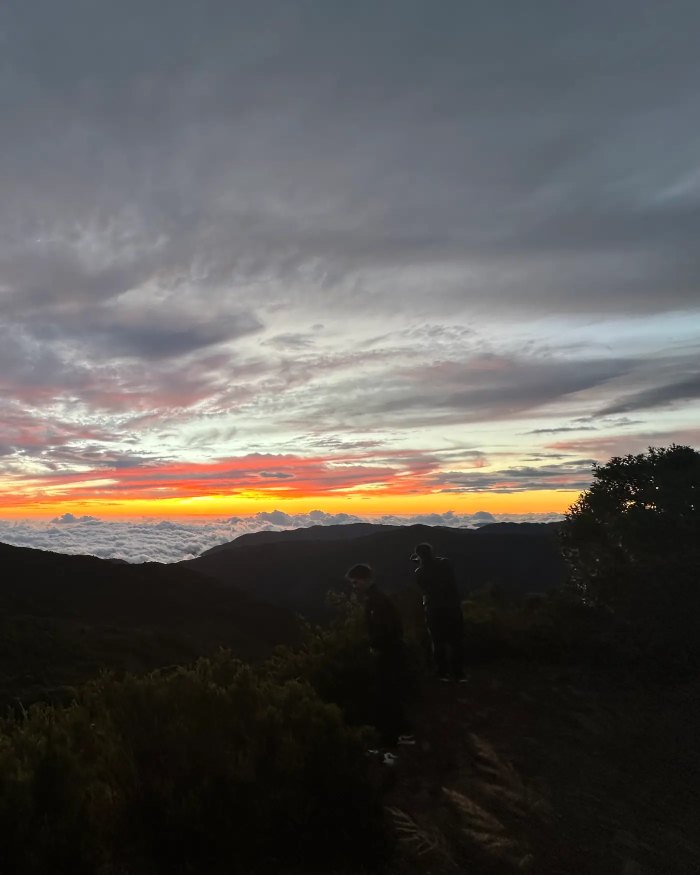 Two figures above a sea of clouds at sunset, Cerro Asunción